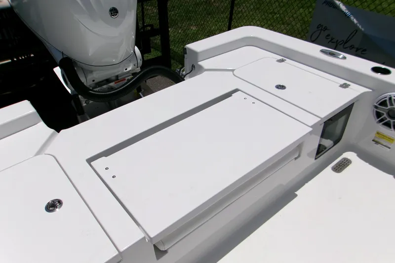 Slide: The Image of 2026 Key West 210 Bay Reef boat deck with storage compartments and motor. - 5