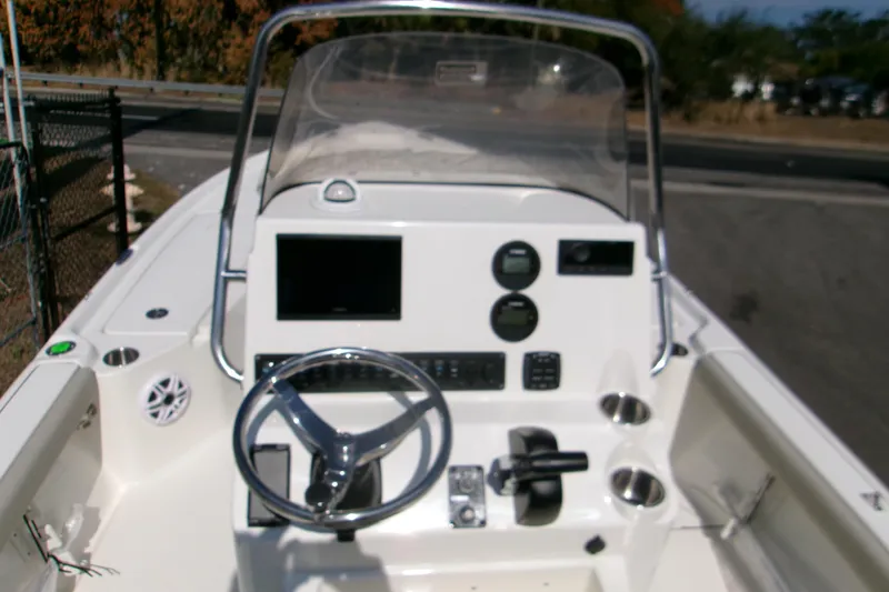 Slide: The Image of 2026 Key West 210 Bay Reef boat dashboard with steering wheel and controls. - 7