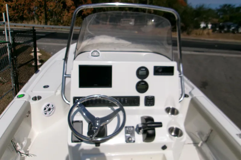Slide: The Image of 2026 Key West 210 Bay Reef boat dashboard with steering wheel and controls. - 8
