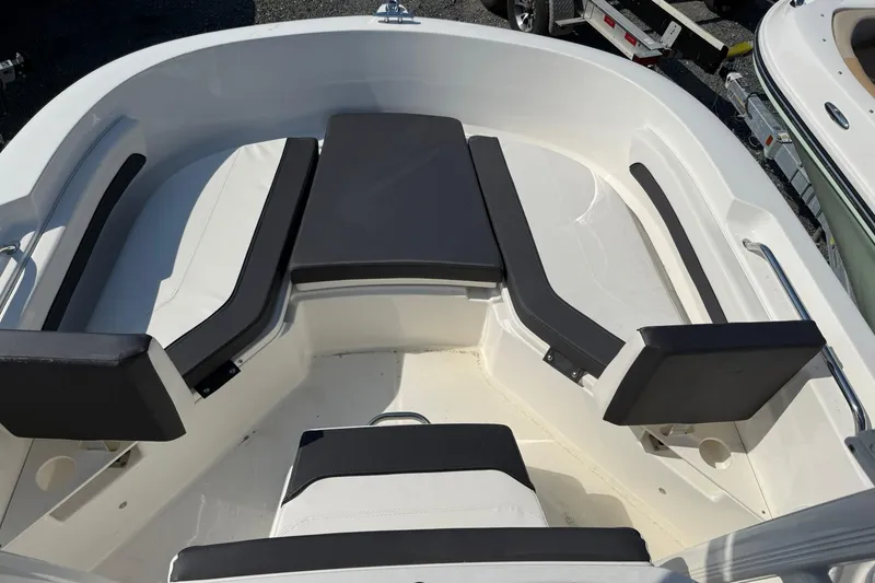 Slide: The Image of 2026 Bayliner Trophy T20CC boat interior with cushioned seating and sleek design. - 11
