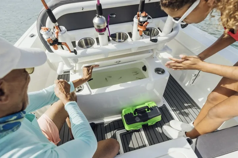 Slide: The Image of Manufacturer Provided Image: 2025 Bayliner Trophy T20CC boat interior with fishing gear and livewell. - 4