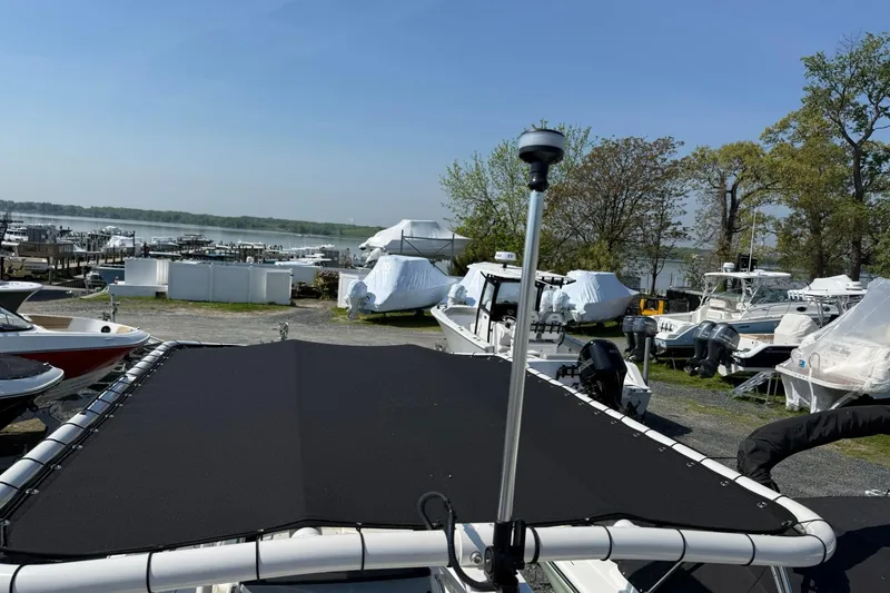 Slide: The Image of 2026 Bayliner Trophy T20CC boat in marina, surrounded by other boats and greenery. - 9