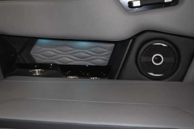 Slide: The Image of 2026 Supra SL 550 interior detail with speaker, cup holders, and ambient lighting. - 11