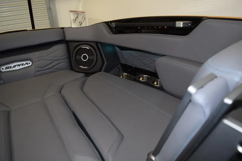 Slide: The Image of 2026 Supra SL 550 interior with premium gray leather seats and integrated speaker system. - 17