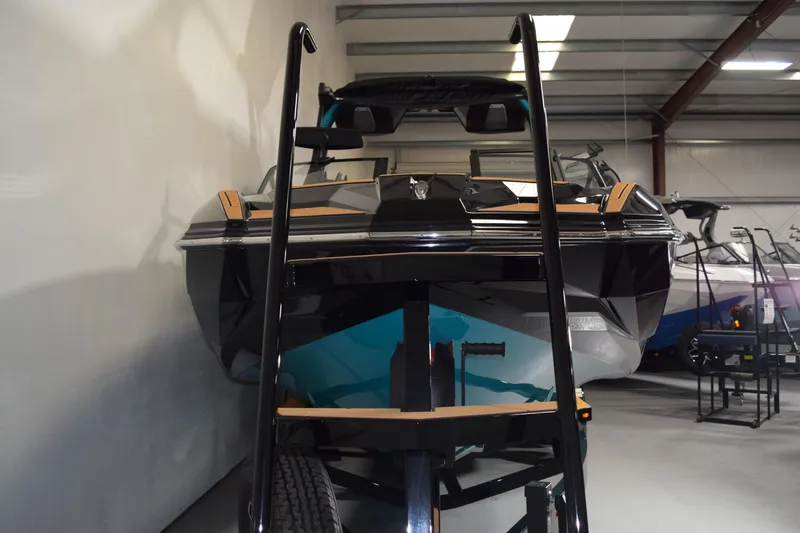 Slide: The Image of 2026 Supra SL 550 boat in showroom, front view with trailer. - 21