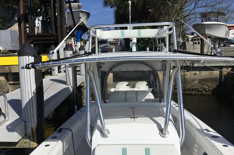 Slide: The Image of 2000 Jupiter 31 Center Console boat docked at marina with fishing equipment. - 10