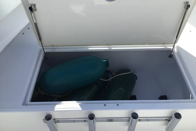 Slide: The Image of Open storage compartment on 2000 Jupiter 31 Center Console boat with fenders inside. - 15