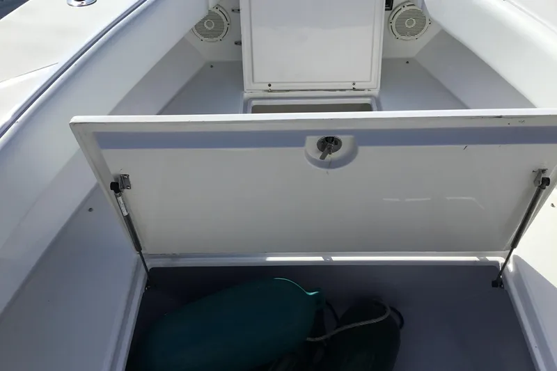 Slide: The Image of Open storage compartment on 2000 Jupiter 31 Center Console boat. - 16