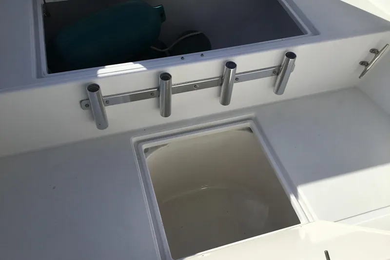 Slide: The Image of 2000 Jupiter 31 Center Console boat interior with rod holders and storage compartments. - 17