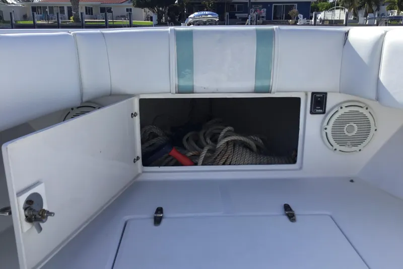 Slide: The Image of Open storage compartment on 2000 Jupiter 31 Center Console boat with ropes inside. - 18