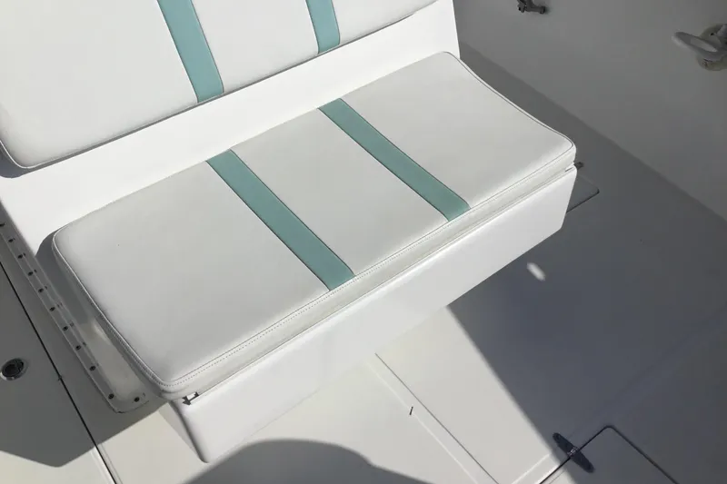 Slide: The Image of White and teal cushioned seat on 2000 Jupiter 31 Center Console boat. - 20