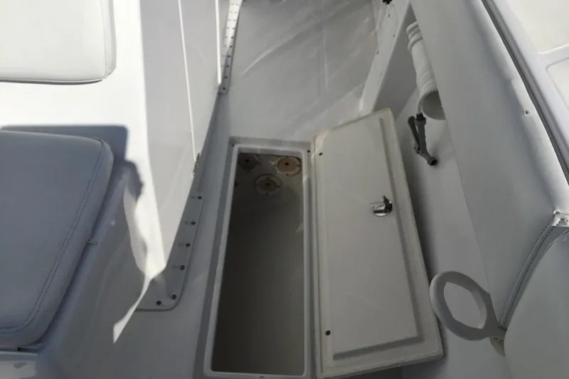 Slide: The Image of Open storage compartment on 2000 Jupiter 31 Center Console boat deck. - 22