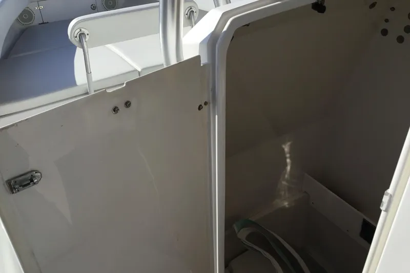 Slide: The Image of Open storage compartment on a 2000 Jupiter 31 Center Console boat. - 26