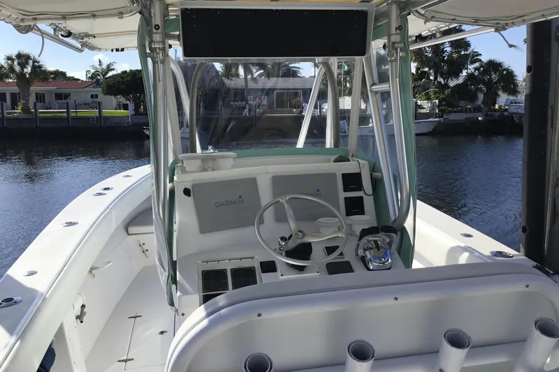 Slide: The Image of 2000 Jupiter 31 Center Console boat interior with steering wheel and Garmin navigation system. - 27