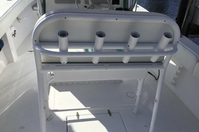 Slide: The Image of 2000 Jupiter 31 Center Console boat interior with rod holders and seating. - 28