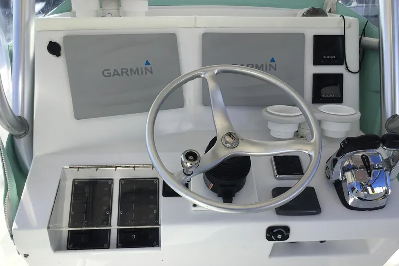 Slide: The Image of Center console of 2000 Jupiter 31 boat with Garmin navigation system and controls. - 29