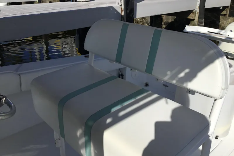 Slide: The Image of White seating on a 2000 Jupiter 31 Center Console boat, with teal accents. - 30