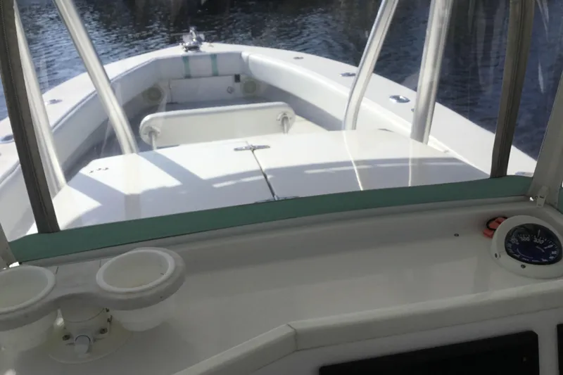 Slide: The Image of 2000 Jupiter 31 Center Console boat interior with steering console and cup holders. - 34