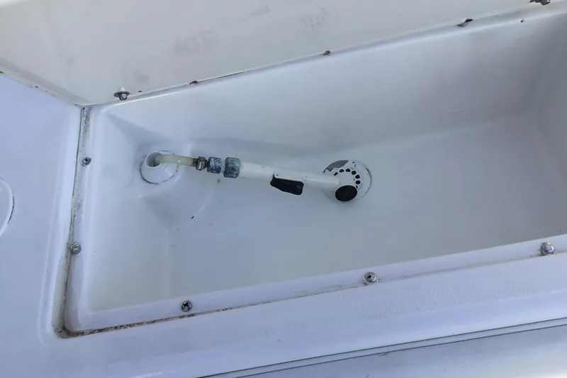 Slide: The Image of Jupiter 31 Center Console 2000 boat compartment with hose attachment. - 38