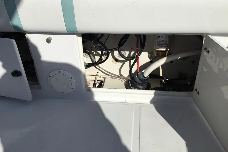 Slide: The Image of Open compartment of 2000 Jupiter 31 Center Console boat showing wiring and components. - 40