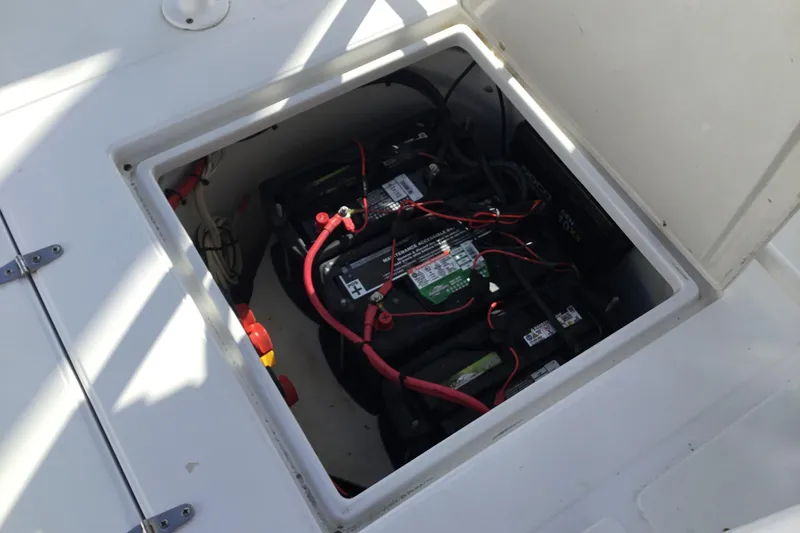 Slide: The Image of Battery compartment of a 2000 Jupiter 31 Center Console boat, showing wiring and connections. - 45