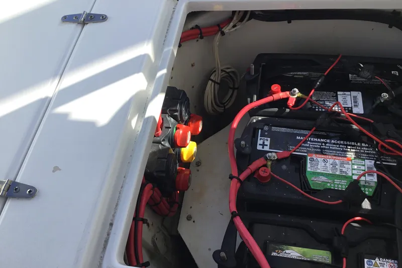 Slide: The Image of Battery compartment of a 2000 Jupiter 31 Center Console boat with wiring and switches. - 47