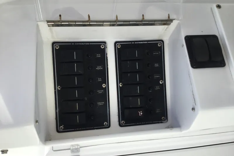 Slide: The Image of Control panel of a 2000 Jupiter 31 Center Console boat, featuring DC distribution switches. - 52