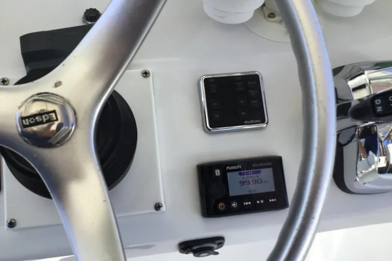Slide: The Image of Steering wheel and controls of 2000 Jupiter 31 Center Console boat. - 53