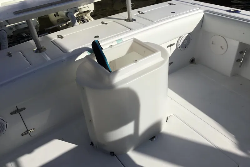 Slide: The Image of 2000 Jupiter 31 Center Console boat interior with storage compartment and clean white deck. - 56