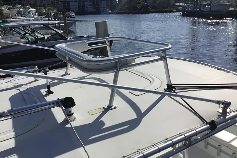 Slide: The Image of 2000 Jupiter 31 Center Console boat with stainless steel railing, docked by the water. - 57