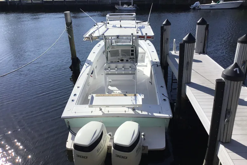 Slide: The Image of 2000 Jupiter 31 Center Console boat docked with twin outboard engines. - 6