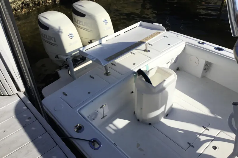 Slide: The Image of 2000 Jupiter 31 Center Console boat with dual Suzuki outboard motors at dock. - 60