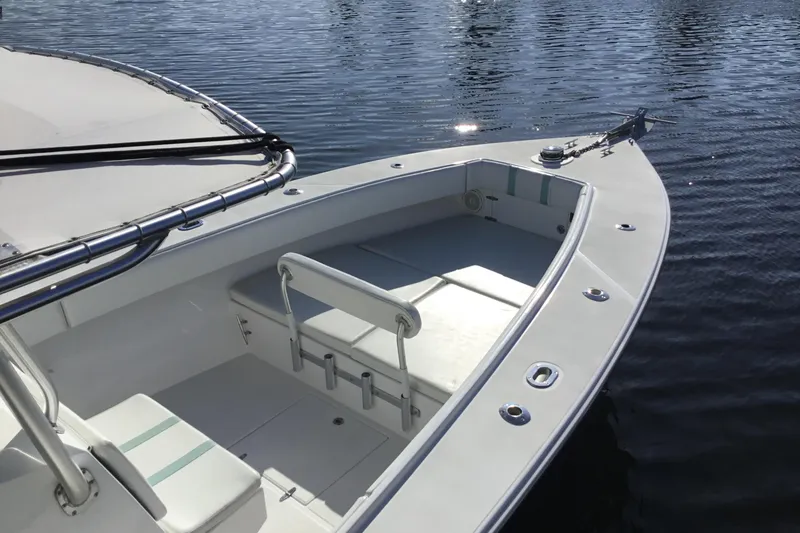 Slide: The Image of 2000 Jupiter 31 Center Console boat on calm water, showcasing spacious deck and seating. - 61