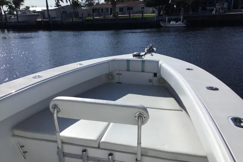 Slide: The Image of 2000 Jupiter 31 Center Console boat on calm water, featuring spacious seating and sleek design. - 7