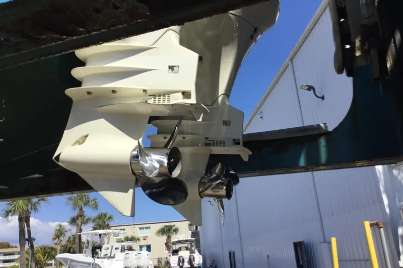 Slide: The Image of Outboard motor of 2000 Jupiter 31 Center Console boat in a marina setting. - 73