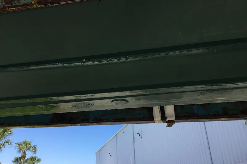 Slide: The Image of Underside view of a 2000 Jupiter 31 Center Console boat with clear sky background. - 74