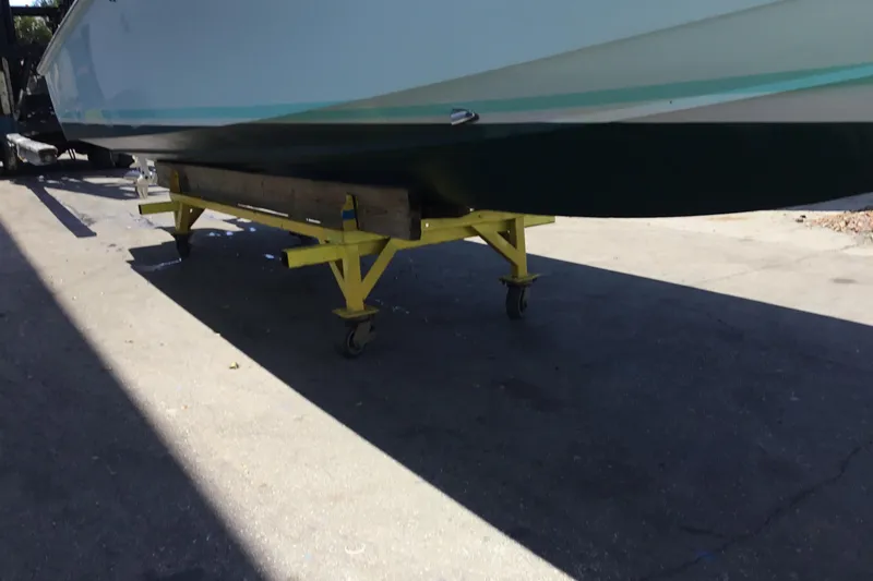 Slide: The Image of 2000 Jupiter 31 Center Console boat on yellow wheeled stand. - 79