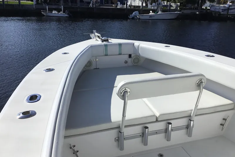 Slide: The Image of 2000 Jupiter 31 Center Console boat with spacious seating and rod holders on calm water. - 8