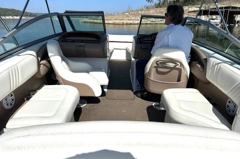 Slide: The Image of 2007 Cobalt 232 boat interior with white seating, steering, and lake view. - 22