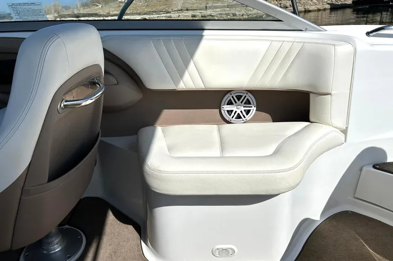 Slide: The Image of Interior of 2007 Cobalt 232 boat with white leather seating and speaker. - 24