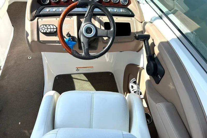 Slide: The Image of Interior of a 2007 Cobalt 232 boat with steering wheel and control panel. - 31