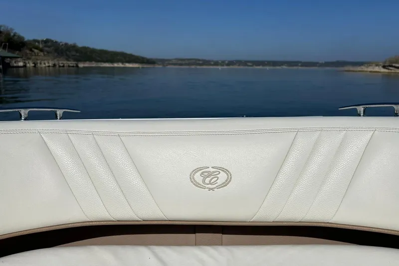 Slide: The Image of 2007 Cobalt 232 boat interior with white leather seating, overlooking a serene lake view. - 37