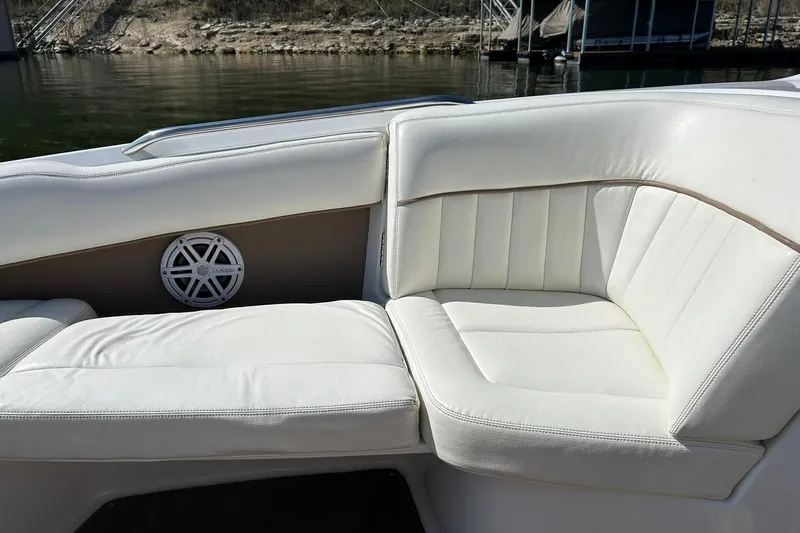 Slide: The Image of White leather seating on a 2007 Cobalt 232 boat, featuring a speaker. - 38