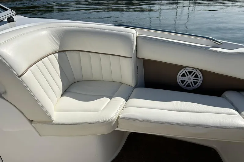 Slide: The Image of Luxurious white seating on a 2007 Cobalt 232 boat, with water in the background. - 40