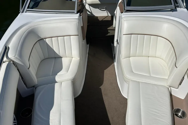 Slide: The Image of Interior of a 2007 Cobalt 232 boat with white leather seating. - 42