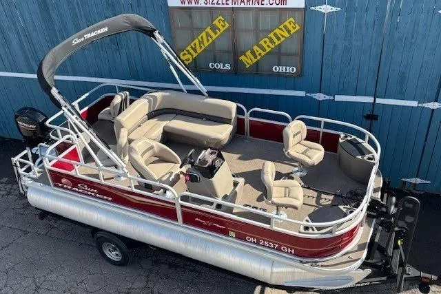 The Image of 2022 Sun Tracker Bass Buggy 18 DLX pontoon boat on trailer, parked outside Sizzle Marine. - 0