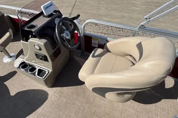 Slide: The Image of 2022 Sun Tracker Bass Buggy 18 DLX boat interior with steering console and beige seating. - 12