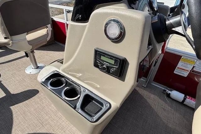 Slide: The Image of 2022 Sun Tracker Bass Buggy 18 DLX console with cup holders and control panel. - 13