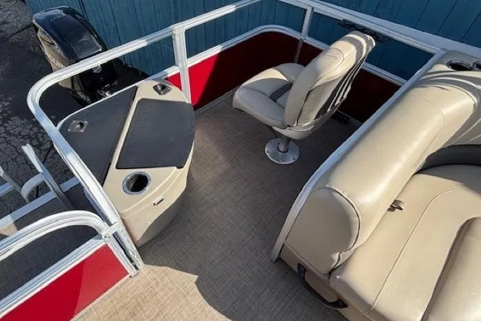 Slide: The Image of 2022 Sun Tracker Bass Buggy 18 DLX interior with seating and control console. - 17