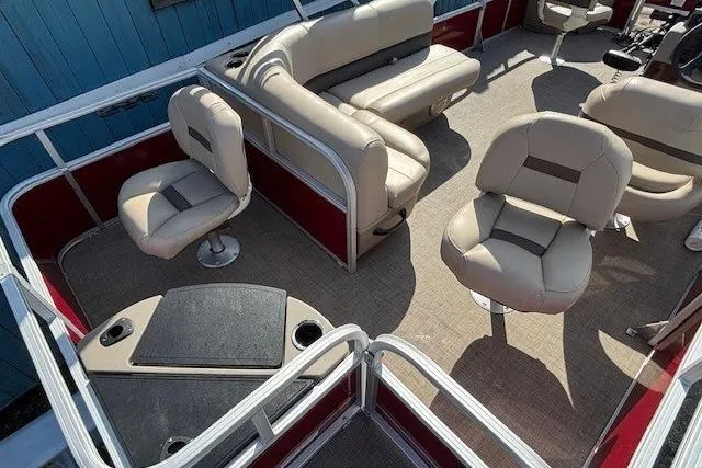 Slide: The Image of 2022 Sun Tracker Bass Buggy 18 DLX pontoon boat interior with beige seating. - 19
